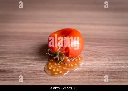 smashed tomato on wooden table Stock Photo