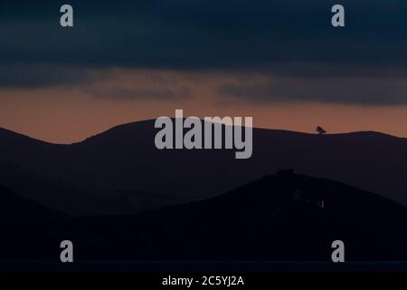 Sunset over coastal mountains near Dunedin, South Island, New Zealand. Stock Photo