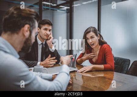 Man and woman arguing in front o their lawyer Stock Photo