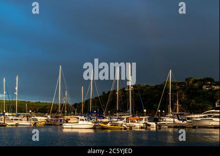 Sunshine And Dark Clouds Over Boats In Torquay Harbour, As Rain 