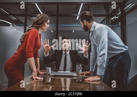Lawyer trying to stop the argument between spouses Stock Photo