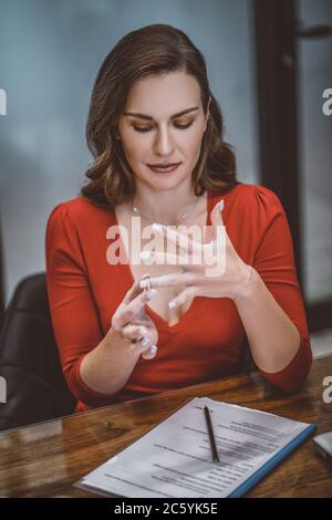 Woman taking off her wedding ring after divorce Stock Photo