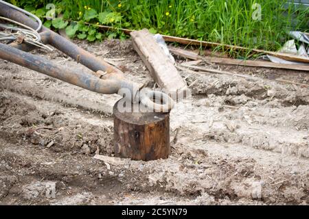 An old rusty trailer and a stump. A trailer for the transport of goods Stock Photo