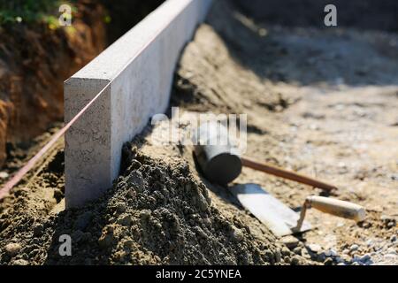 Putting a curb, construction site Stock Photo