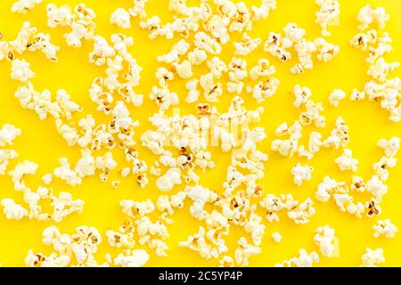Popcorn scattered on yellow background top view Stock Photo