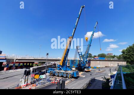 Sarens cranes that have been rigged to lift sections of bridge, from Regent Street Flyover of the A64M in Leeds City Centre Stock Photo