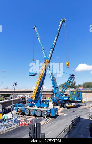 Sarens cranes that have been rigged to lift sections of bridge, from Regent Street Flyover of the A64M in Leeds City Centre Stock Photo