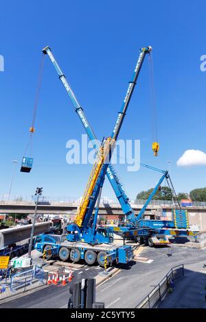 Sarens cranes that have been rigged to lift sections of bridge, from Regent Street Flyover of the A64M in Leeds City Centre Stock Photo