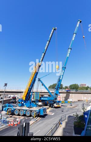 Sarens cranes that have been rigged to lift sections of bridge, from Regent Street Flyover of the A64M in Leeds City Centre Stock Photo