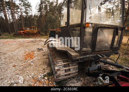 Old rusty tractors in countryside in woods Stock Photo