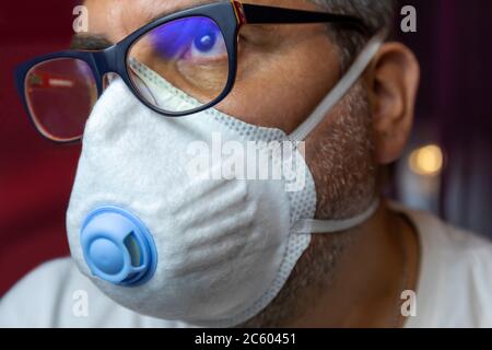 Closeup of man with a protective medical mask waits for the end of the emergency quarantine covid-19.