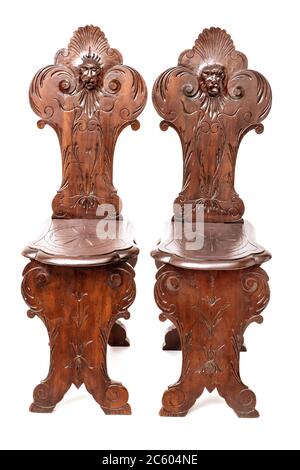 A pair of od fashioned wood chair in the gothic stryle on the white background. Stock Photo