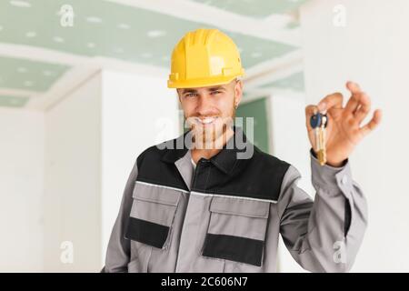 Portrait of smiling engineer in work clothes and hardhat happily Stock Photo