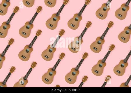 Hawaiian guitars pattern on a pink pastel background. Creative layout. Stock Photo