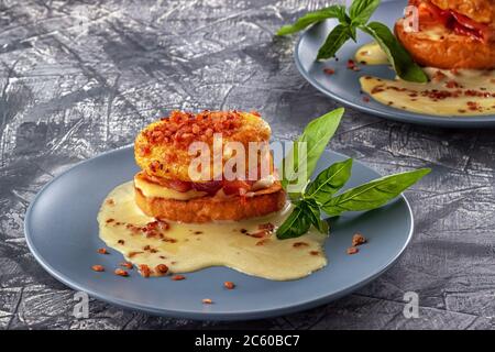 Eggs Benedict on toasted muffins with ham and sauce Stock Photo