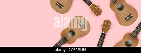 Pattern made of hawaiian guitars on a pink pastel background. Banner with place for your design. Stock Photo