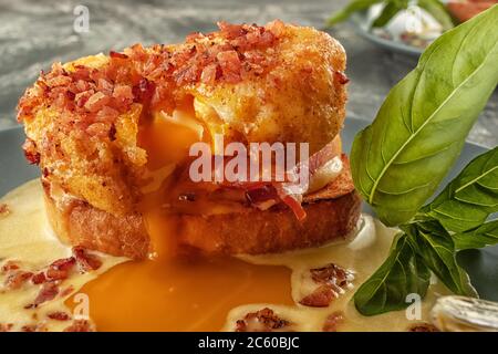 Eggs Benedict on toasted muffins with ham and sauce Stock Photo