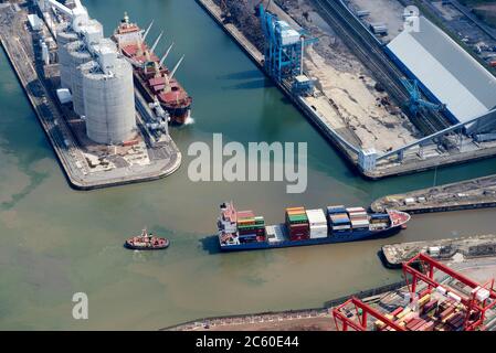 An aerial view of a container ship leaving Seaforth Docks, Liverpool, Merseyside, North West England, UK Stock Photo
