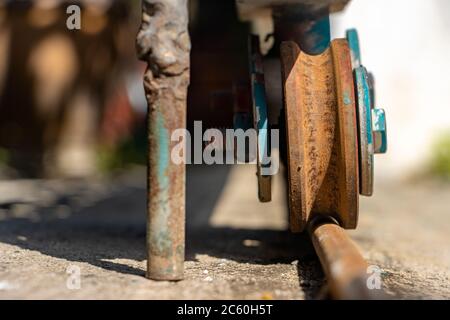 A rusty wheel from sliding gate on a rail, close up view Stock Photo