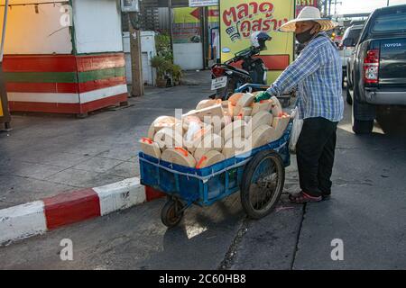 SAMUT PRAKAN, THAILAND, JUN 23 2020, The seller of wooden boards pushing full trolley to the market. Stock Photo