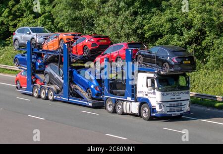 Nelson car transport, Honda Civic car  movers, Lorries & Trucks,  collection and deliveries, shipping freight, heavy haulage, lorry logistics, Volvo delivery transport vehicles on the M6 at Lancaster, UK Stock Photo
