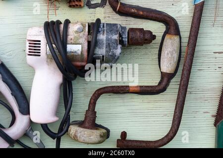 Rusty tools mounted on wooden wall, near Bulls, Manawatu, North Island, New Zealand Stock Photo