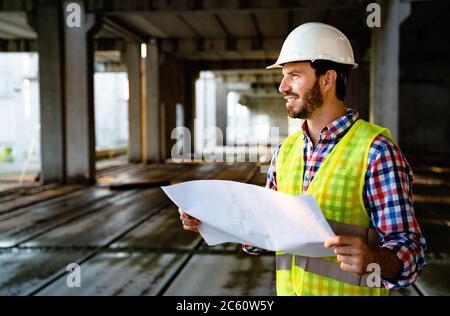 Portrait of construction architect, engineer working on building site Stock Photo