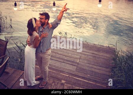 top view of a couple hugging and smiling on the riverside Stock Photo