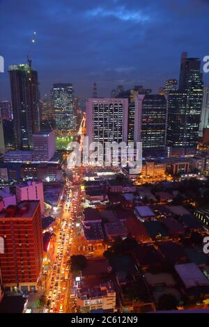 Aerial night view of Manila with traffic congestion and brightly lit ...