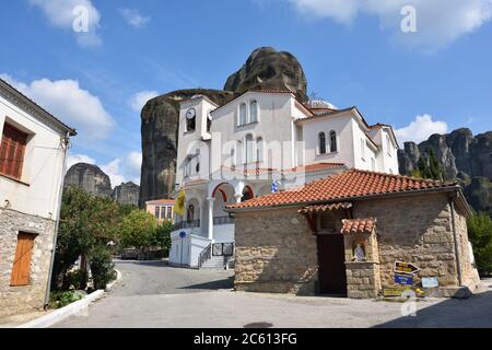 Meteora, Greece - Sept 27, 2016: Outdoor view on the traditional Greek white building of the Church at the center of Kastraki village surrounded with Stock Photo