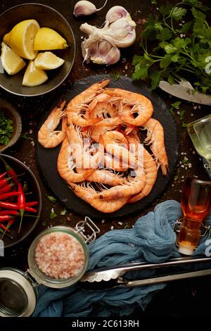Fresh and raw big shrimps ready to be prepared. With various ingredients on side Stock Photo
