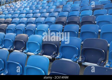 Stadium seats - empty sports venue. Blue plastic chairs. Stock Photo