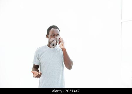 serious young man talking on his smartphone. Stock Photo
