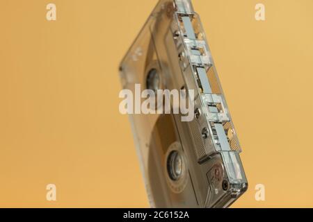 Close up Audio cassette tape on a white table and yellow space.Minimalism retro style concept. 80s. Background pattern for design. Stock Photo