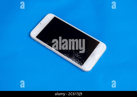 Broken mobile phone. Cracked smartphone screen Stock Photo