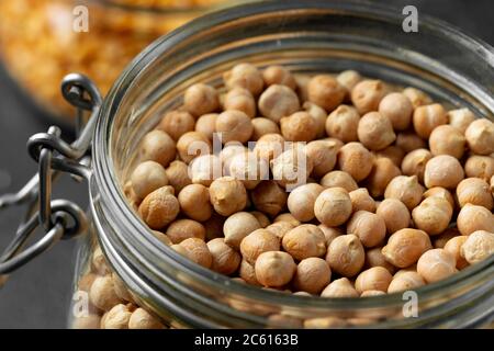 Uncooked dried chickpeas in glass jar close up Stock Photo