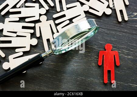 Human resource management and talent choice. Magnifying glass and figures. Stock Photo