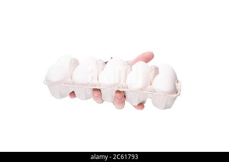 male hand with white mouth with eggs through a hole in paper on a white background isolate. close up, copy space. Stock Photo