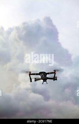 Close up of a wifi enabled, recreational DJI Mavic Pro Aerial 4K Camera Drone Quadcopter flying low overhead. Stock Photo