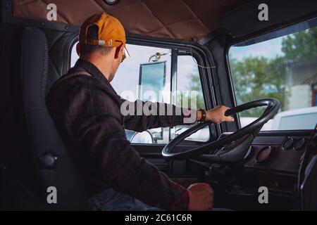 https://l450v.alamy.com/450v/2c61c6r/caucasian-trucker-in-his-40s-inside-vintage-aged-semi-truck-tractor-cabin-transportation-industry-2c61c6r.jpg