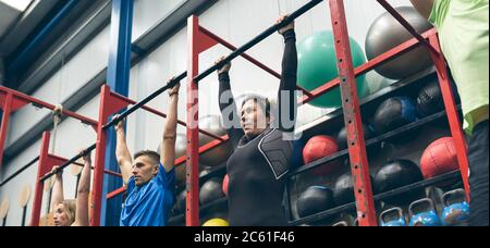 Athletes ready to do pull ups in the box Stock Photo