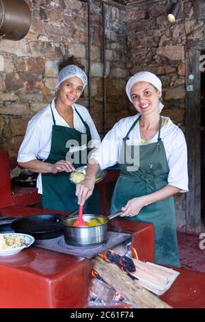 Two Brazilian chefs working in a kitchen in Ibitipoca, Minas Gerais, Brazil Stock Photo