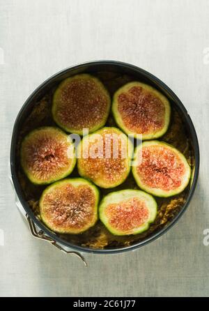 raw cake with figs in a baking dish, ready to be baked in the oven Stock Photo