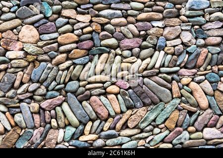 Wall from colorful pebble stones Stock Photo