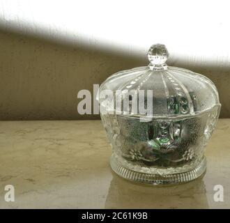 Glass Candy, normally used at home to store candies and sweets, has an old, retro style, can be in glass or crystal, with a lid, photographed on a tra Stock Photo