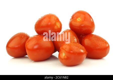 four fresh and colorful italian plum tomatoes on a white background Stock Photo
