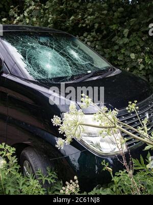 Vandalised car Smashed windscreen Hammer Bullets Stock Photo