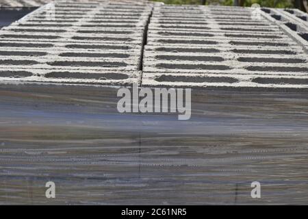 Set of concrete blocks for building concrete walls on a farm, in side view, with blue sky in the background, Brazil, South America, style texture or s Stock Photo
