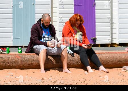 Goodrington Sands, Paignton, Devon, UK.  6th July 2020.   UK Weather:  Holidaymakers on the beach at Goodrington Sands at Paignton in Devon on a day of warm sunny spells.  Picture Credit: Graham Hunt/Alamy Live News Stock Photo