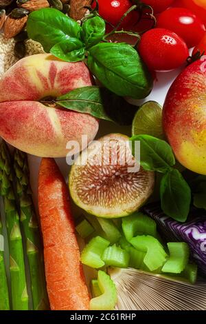 basic vegan ingredients and products. cereals, legumes, fresh vegetables and fruits, oils, seeds and nuts. balanced healthy diet isolated on white Stock Photo